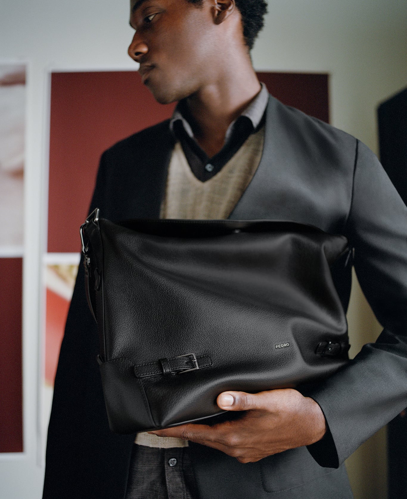 Jabari Wimbley holding a black PEDRO bag in front of him