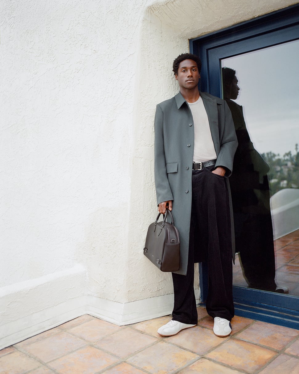 Jabari Wimbley standing in a doorway holding a brown PEDRO bag