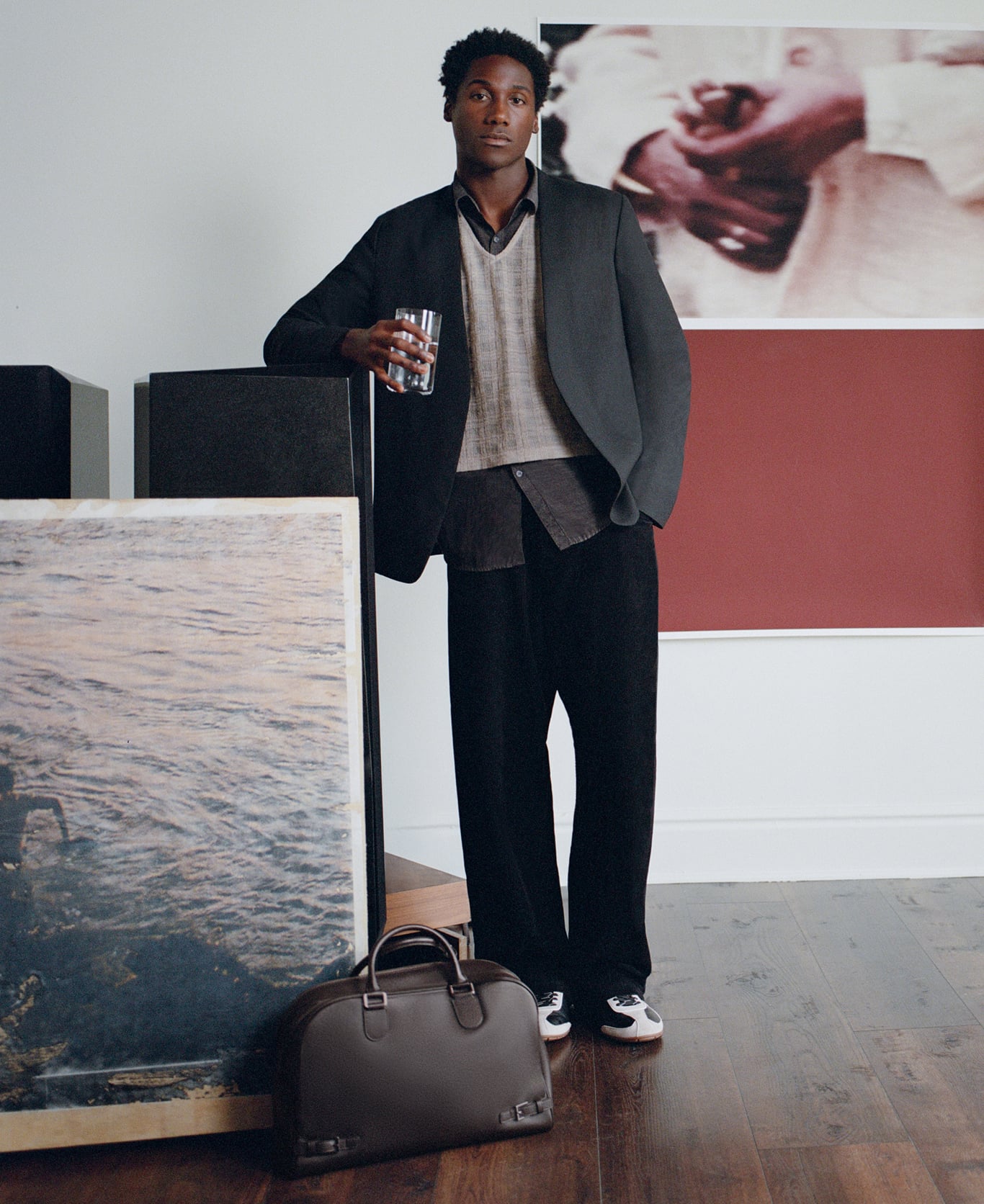 Jabari Wimbley in his studio holding a black PEDRO bag