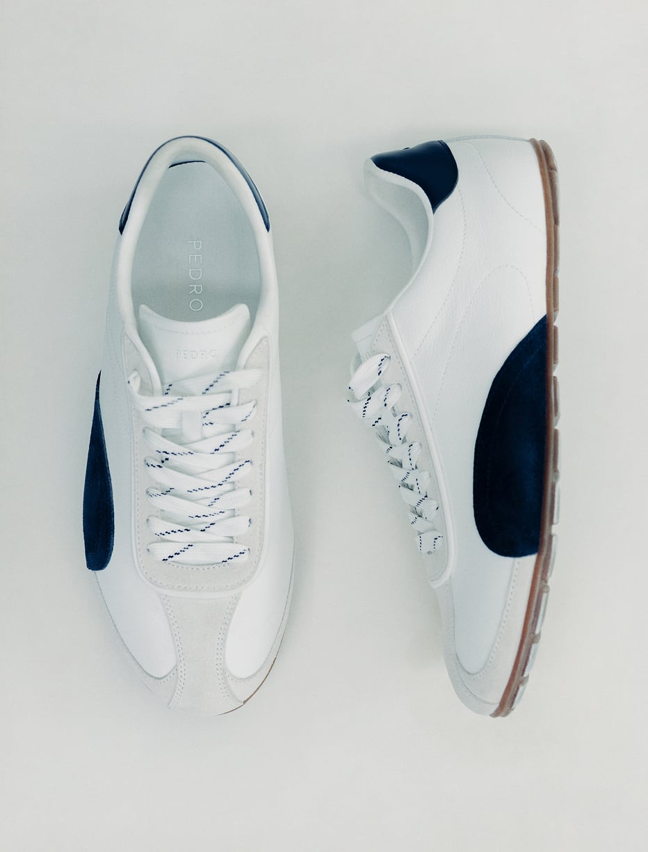 A pair of white PEDRO sneakers with navy panels