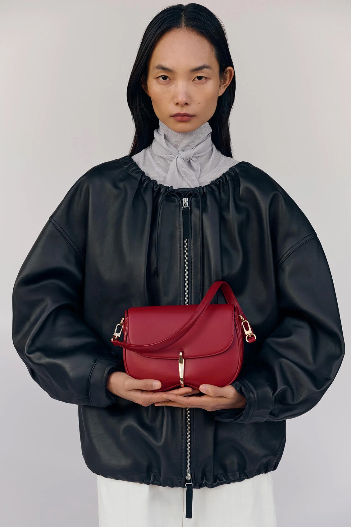 Model holding red bag
